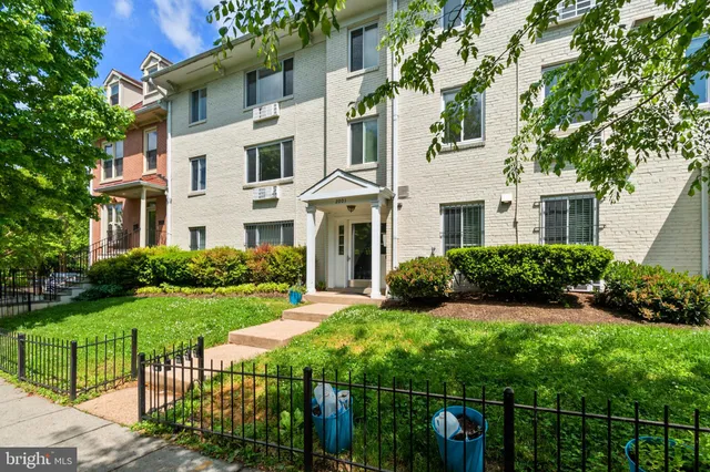a front view of a house with a yard table and chairs