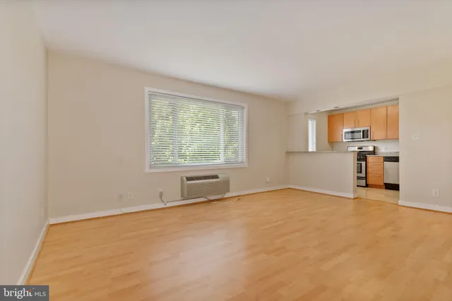 an empty room with furniture and windows