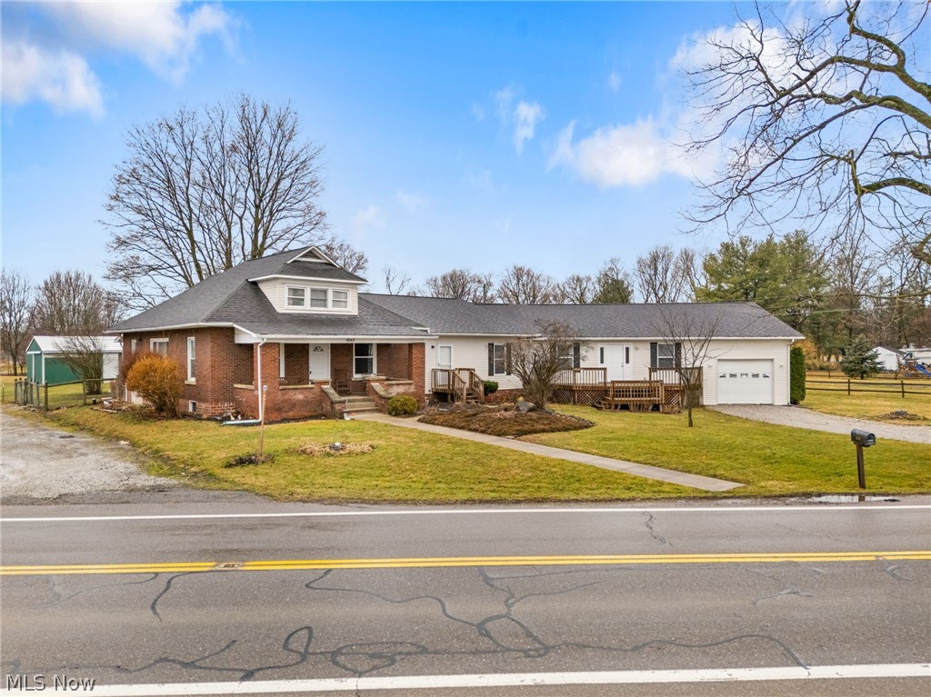 1640 Old Delaware Road Mount Vernon, OH 43050 - Photo 2 of 49 View of front of property featuring gravel driveway, covered porch, an attached garage, brick siding, and a shingled roof
