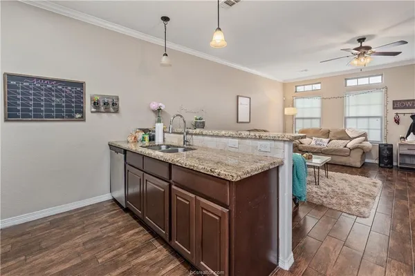 a kitchen with stainless steel appliances granite countertop a refrigerator and a stove top oven