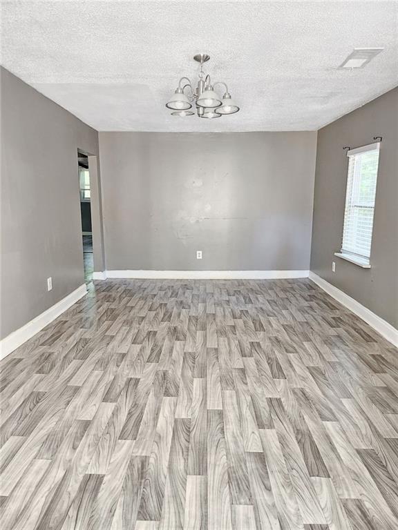 147 Cobb Road Covington, GA 30014 - Photo 13 of 21 a view of an empty room with wooden floor and a window