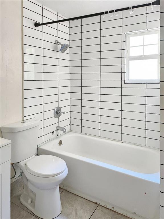 147 Cobb Road Covington, GA 30014 - Photo 14 of 21 a bathroom with a white toilet sitting next to a window