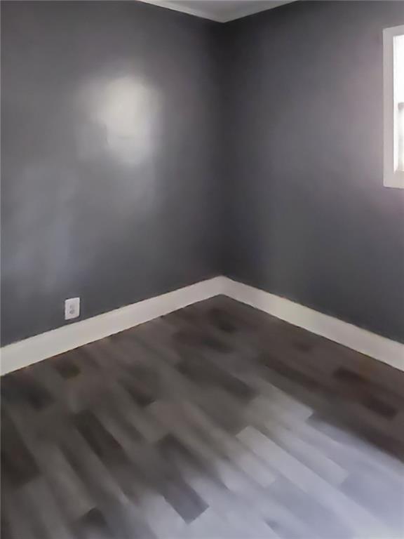 147 Cobb Road Covington, GA 30014 - Photo 15 of 21 an empty room with wooden floor and windows