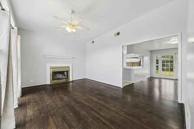 a view of main area fire place window and wooden floor