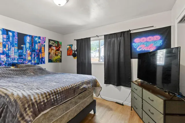 a bedroom with a bed and a flat screen tv