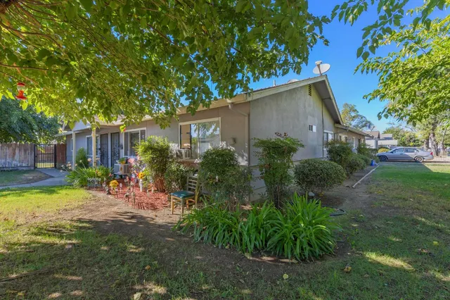 a view of a backyard with plants and a patio