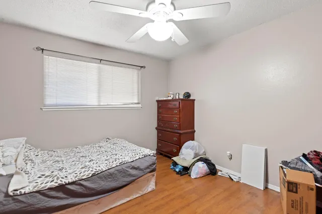 a bedroom with a bed and a chandelier