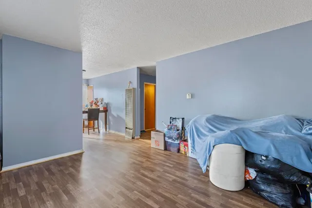 a bedroom with furniture and a wooden floor