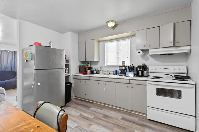 a kitchen with a refrigerator sink and cabinets