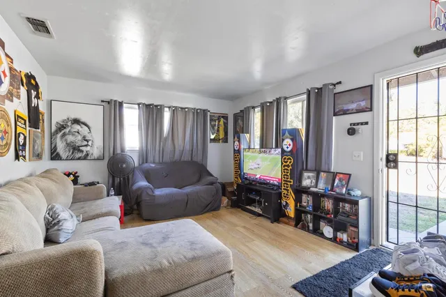 a living room with furniture and a bookshelf