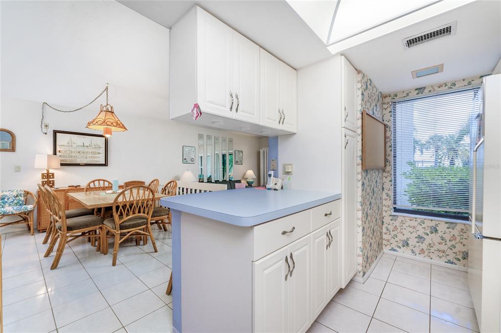 2955 North Beach Road, Unit B614 Englewood, FL 34223 - Photo 22 of 67 a kitchen with stainless steel appliances granite countertop a sink and a refrigerator