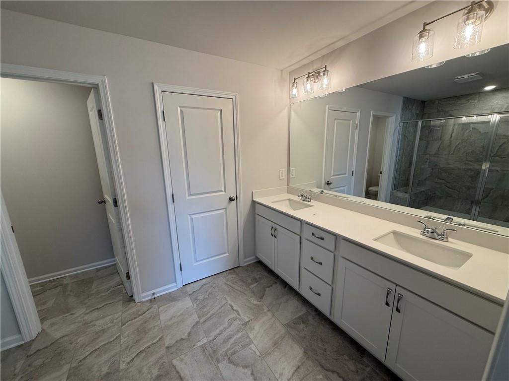 5139 Longview Run Decatur, GA 30035 - Photo 16 of 16 a spacious bathroom with a double vanity sink a large mirror and a shower