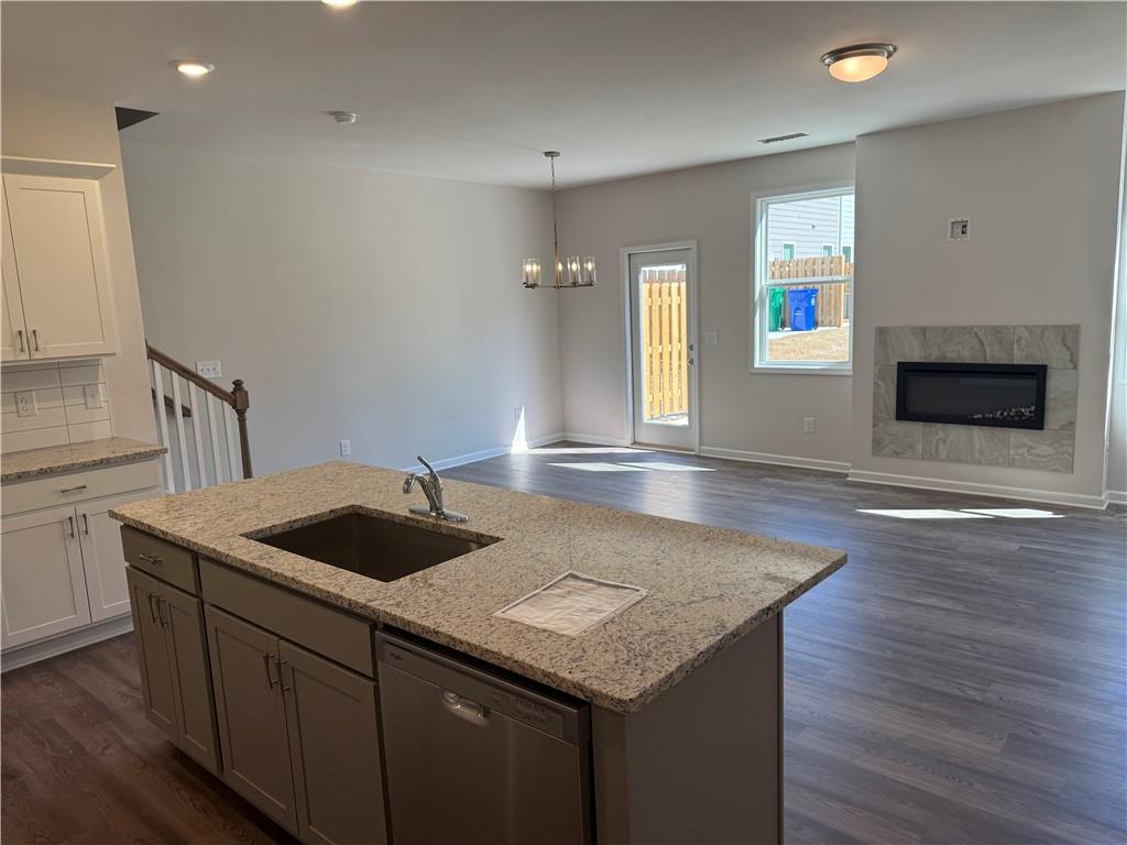 5139 Longview Run Decatur, GA 30035 - Photo 4 of 16 a kitchen with a granite countertop sink and dishwasher with wooden floor