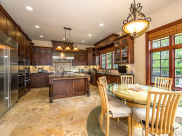 632 Fairway Circle Hillsborough, CA 94010 - Photo 7 of 18 a kitchen with stainless steel appliances kitchen island granite countertop a stove a refrigerator a oven a sink with a dining table and chairs
