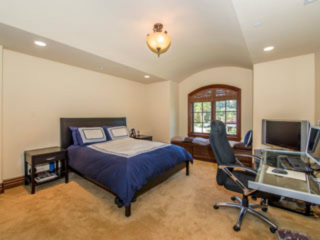 632 Fairway Circle Hillsborough, CA 94010 - Photo 8 of 18 a bedroom with a bed a chair and a chandelier