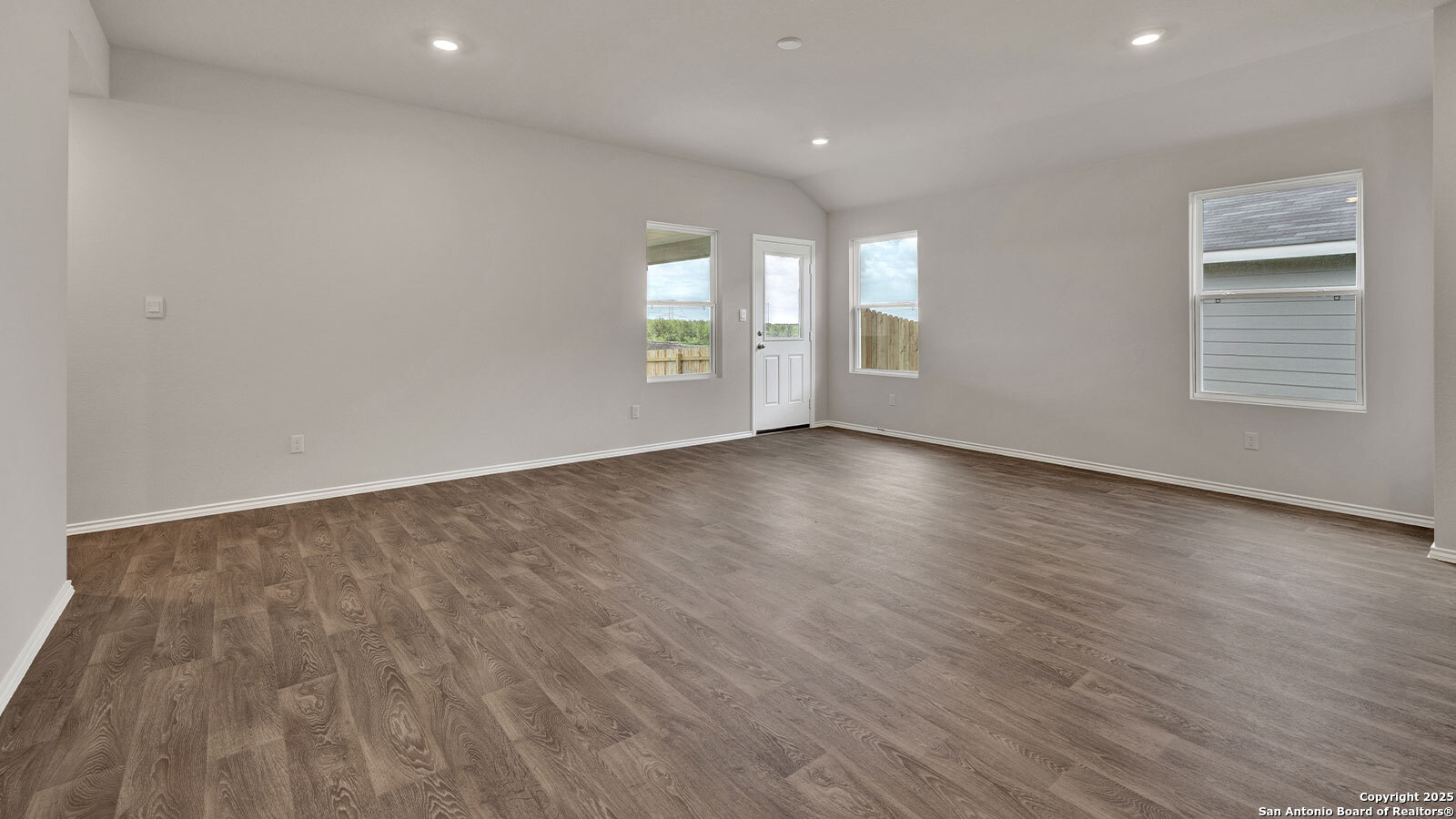 322 Hodges Street Maxwell, TX 78656 - Photo 17 of 34 an empty room with wooden floor and windows