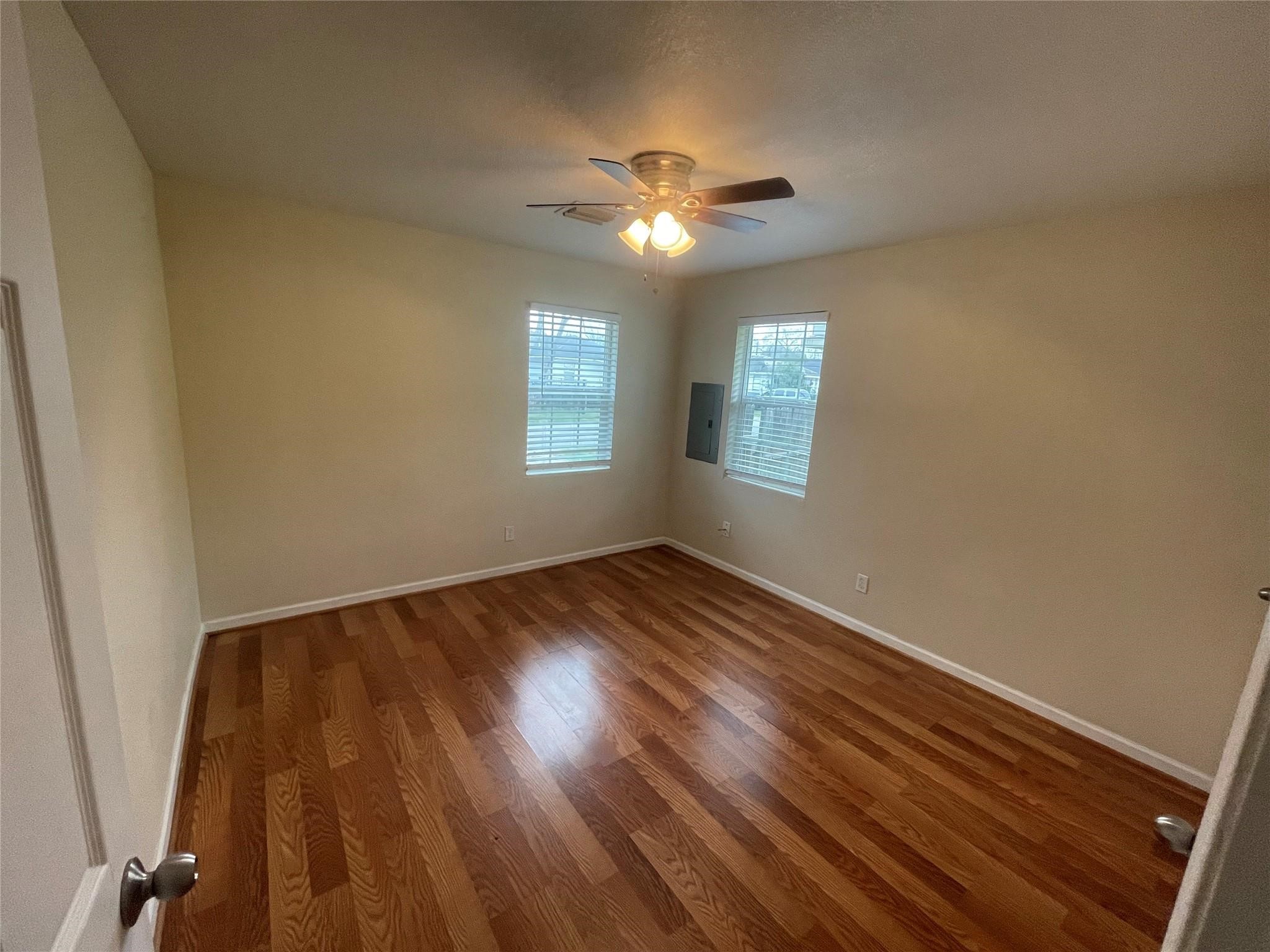 6315 Sayers Street Houston, TX 77026 - Photo 5 of 11 a view of an empty room with wooden floor and a window