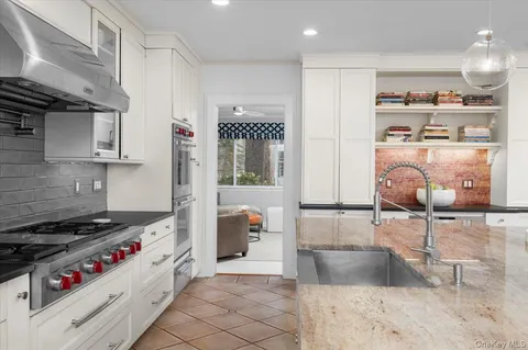 a kitchen with granite countertop a stove and a refrigerator
