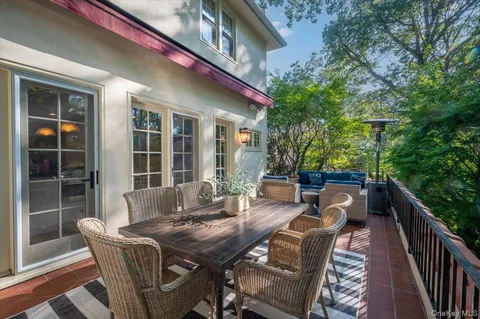 a view of a house with backyard and sitting area