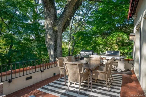 a view of a patio with table and chairs and wooden floor