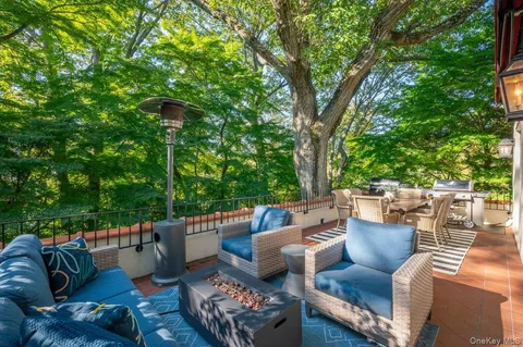 a view of a patio with couches chairs and a fire pit