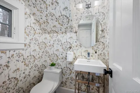 a bathroom with a sink toilet and mirror