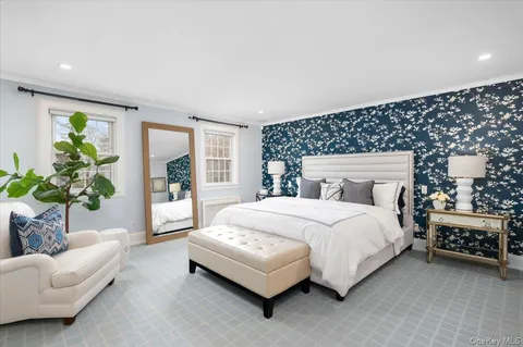 a bedroom with a bed couch and window