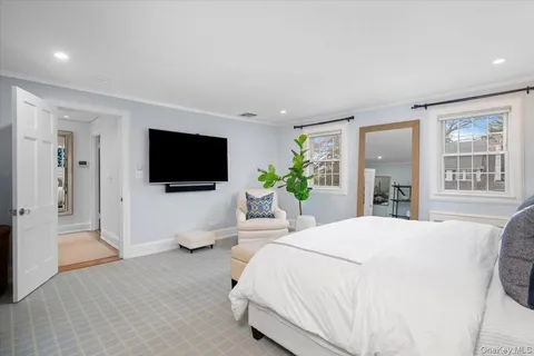 a bedroom with a bed and a flat screen tv