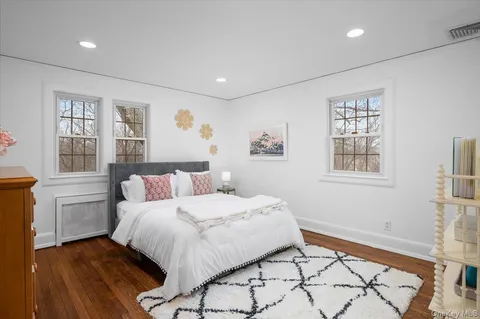a bedroom with a large bed and a window