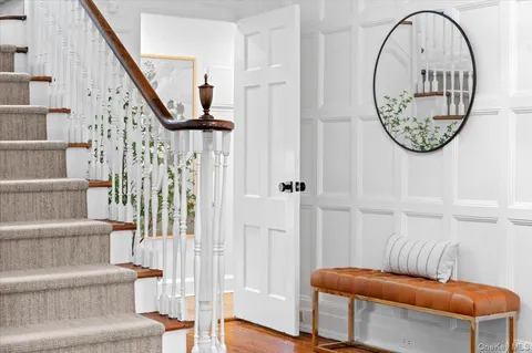 a view of entryway with wooden floor and a front door