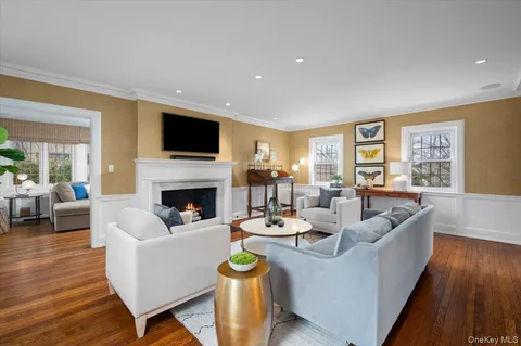a living room with furniture fireplace and flat screen tv
