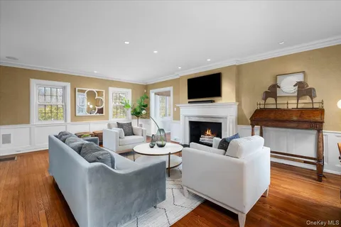 a living room with furniture fireplace and flat screen tv