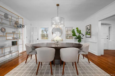 a view of a dining room with furniture and chandelier