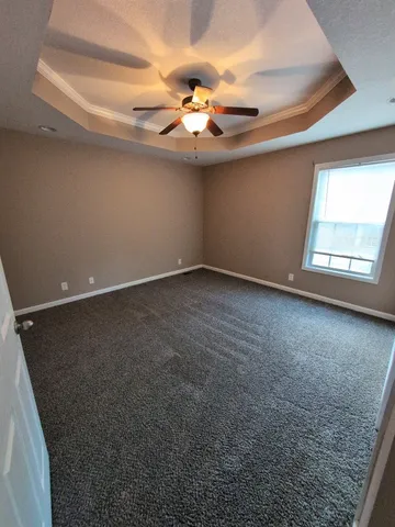 a view of a livingroom with a ceiling fan and window