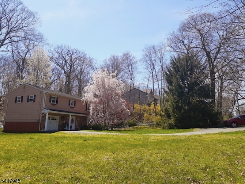 47 Indian Trail Hopatcong, NJ 07821 - Photo 15 of 17 a brick house with a big yard and large trees