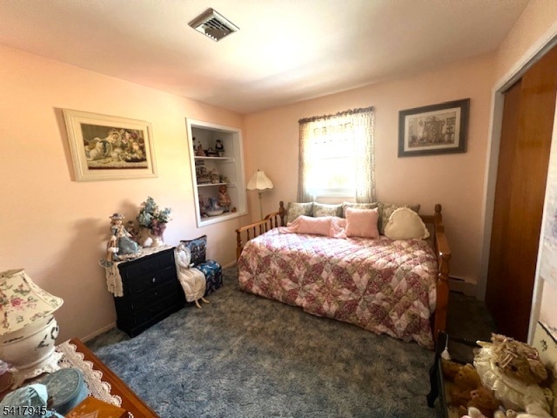 47 Indian Trail Hopatcong, NJ 07821 - Photo 3 of 17 a bedroom with a bed and wooden floor