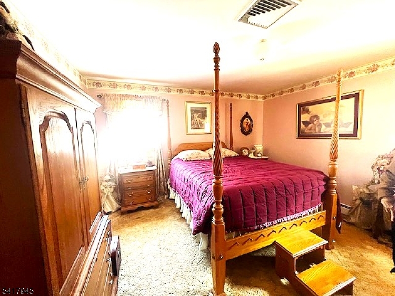 47 Indian Trail Hopatcong, NJ 07821 - Photo 4 of 17 a bedroom with a bed dresser and a window