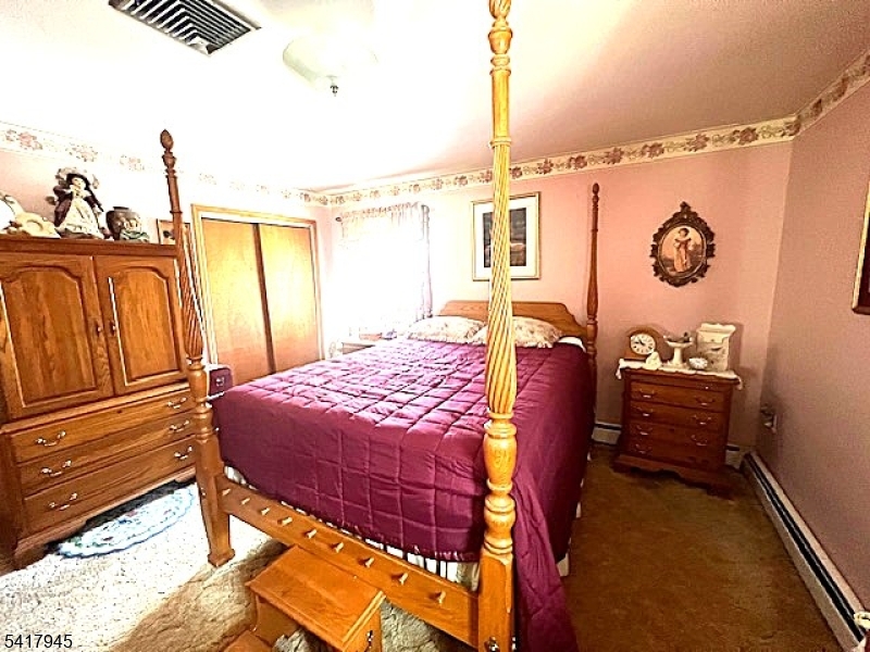 47 Indian Trail Hopatcong, NJ 07821 - Photo 5 of 17 a bedroom with a bed and a dresser next to a window