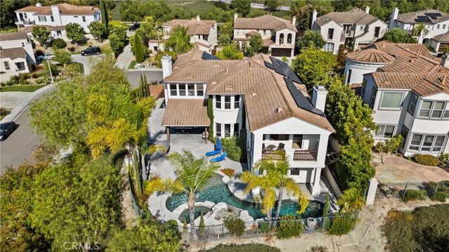 an aerial view of a house with a big yard and large trees