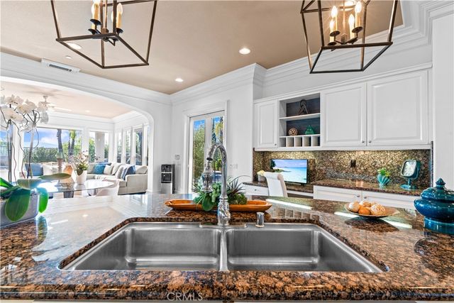 a kitchen with granite countertop a sink and a counter top space