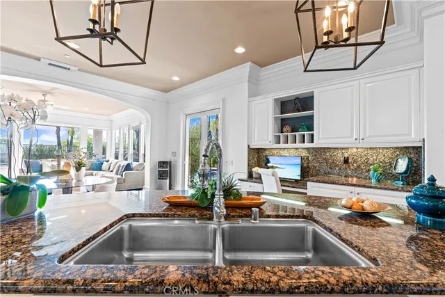 a kitchen with granite countertop a sink and a counter top space