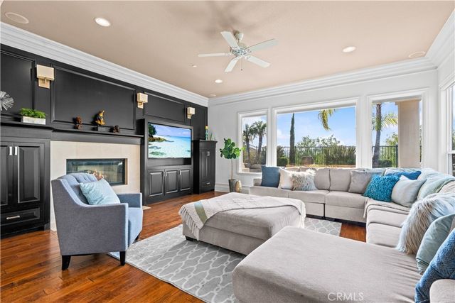 a living room with furniture fireplace and a large window