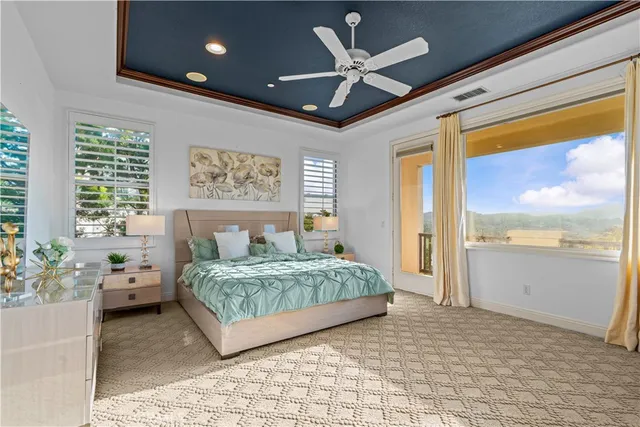 a bedroom with a large bed and a large window