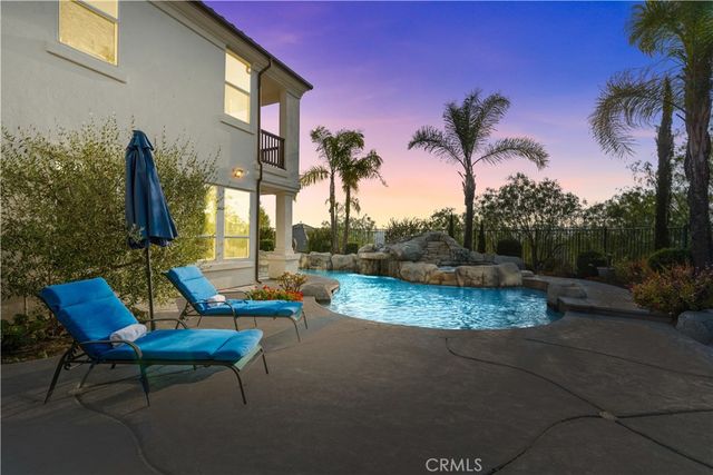 a view of a patio with couches table and chairs and potted plants