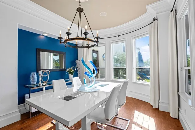 a view of a dining room with furniture wooden floor and a chandelier