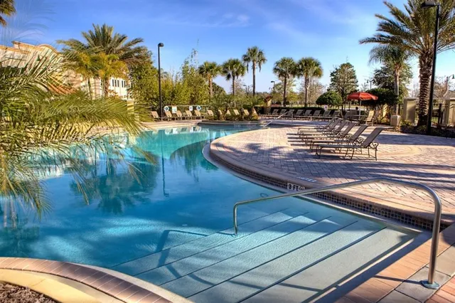 a view of a swimming pool with a table and chairs