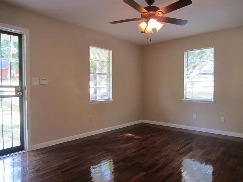 53 West Rollins Road Memphis, TN 38109 - Photo 2 of 16 a view of an empty room with wooden floor and a window