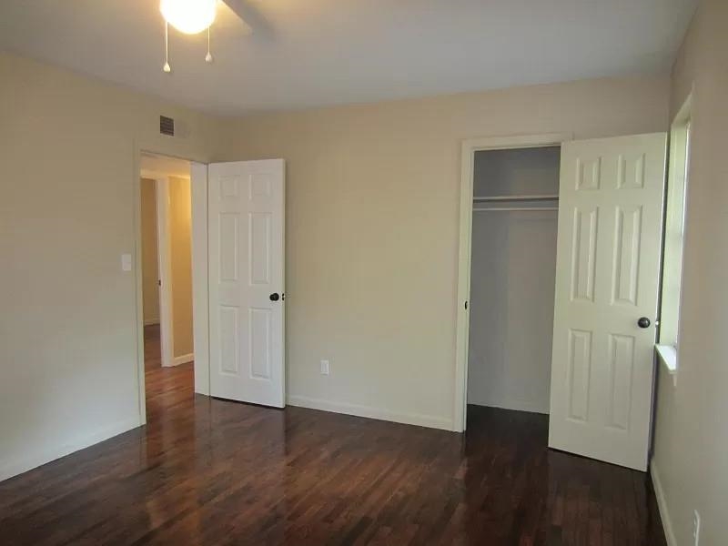 53 West Rollins Road Memphis, TN 38109 - Photo 6 of 16 an empty room with wooden floor and closet area