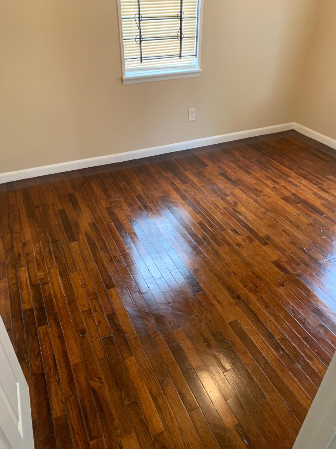 53 West Rollins Road Memphis, TN 38109 - Photo 9 of 16 a view of an empty room with wooden floor and a window