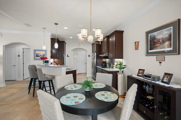 a view of a dining room with furniture and chandelier